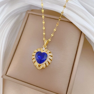 Detail of blue heart pendant with micro-paved zircons on elegant champagne box