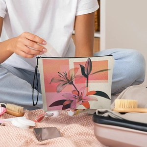 Elegant lily floral canvas toiletry bag with zipper and handle shown in a travel setting