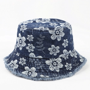 Blue denim bucket hat with white floral embroidery and stylish frayed brim edges