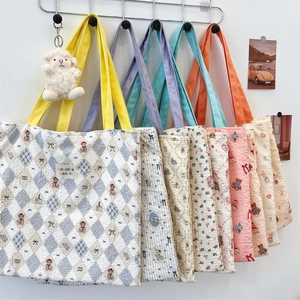 Detailed view of waffle texture canvas tote bags with bear prints and plush sheep charm