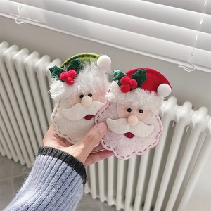 Close-up of handmade felt Santa Claus ornaments in festive red and green colors