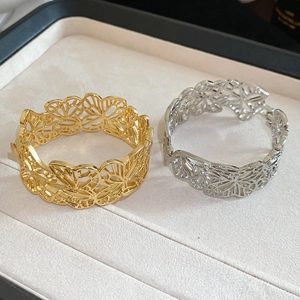 Detail shot of hollow butterfly metal bracelets in gold and silver finish in gift box