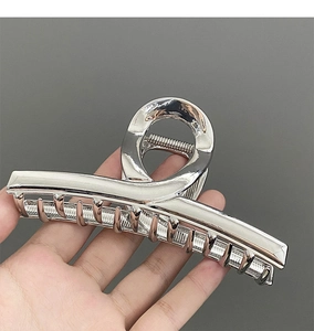 Detailed view of large silver metal hair claw clip with wide surface and smooth finish