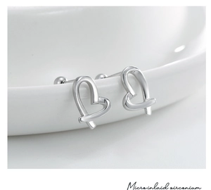 Detailed macro view of S925 sterling silver heart earrings with micro-inlaid zircon