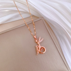 Elegant rose gold fairy pendant necklace with dancing diamond on a silk background