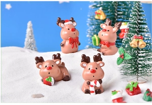 Detailed view of four resin Christmas reindeer figurines in diverse festive poses