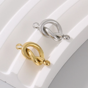 Detailed view of polished gold and silver heart-shaped DIY jewelry connectors for necklaces