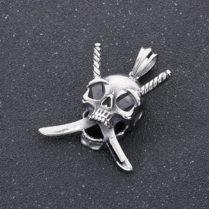 Macro shot of a silver gothic skull pendant with crossed daggers in stainless steel