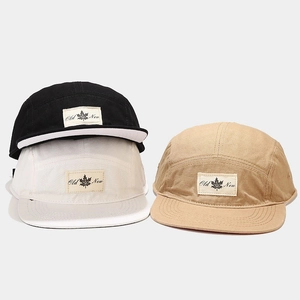 Flat brim camper hats in black, white and khaki with vintage maple leaf labels