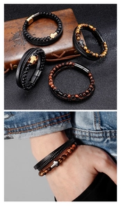 Detail of multi-layer leather bracelet with tiger eye beads and metal cross on wrist