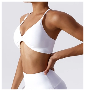 Detail of white sports bra featuring a knot front design and criss-cross back straps