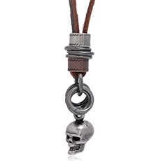 Detail shot of vintage leather cord necklace featuring a metallic punk skull pendant