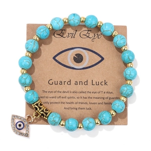 Natural stone bead bracelet with turquoise finish and evil eye charm on display card