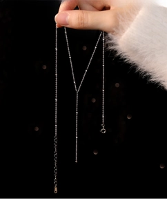 Detail of S925 sterling silver tassel bead chain with high polish and minimalist finish
