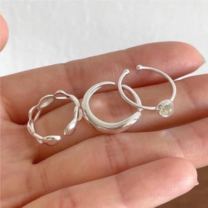 Detailed view of 925 silver ring set featuring openwork leaves and yellow gemstone