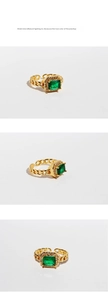 Macro shot of French retro emerald square zircon ring with gold chain band details