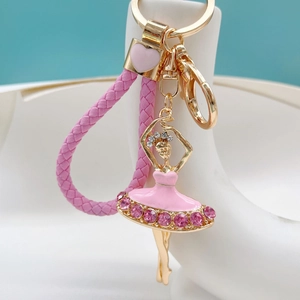 Detail of pink ballet girl keychain with sparkling rhinestones and woven leather strap