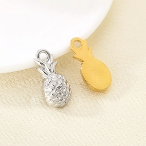 Detail of pineapple pendants in gold and silver finishes for DIY jewelry making