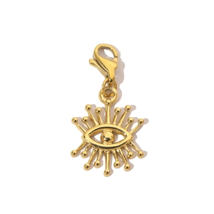 Macro shot of gold evil eye pendant with lobster clasp and shiny diamond inlay