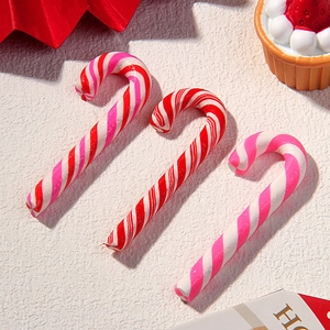 Macro shot of striped polymer clay candy cane charms for DIY accessories and crafts