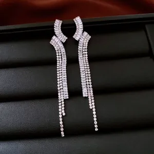 Silver drop earrings with geometric zircons and long tassels on black leather base