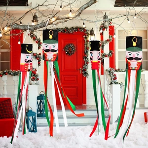 Outdoor Nutcracker windsock set with four soldier designs hanging on a snowy porch decor
