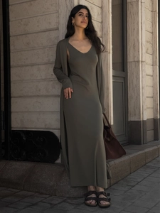 Detail of dark olive green knit long dress and cardigan set with soft texture