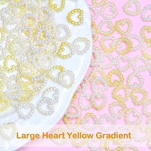 Macro shot of yellow gradient heart-shaped ABS pearls for DIY hair accessory making