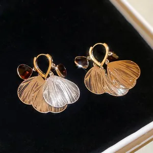 French vintage gold petal tassel earrings with red crystal pendant on black background