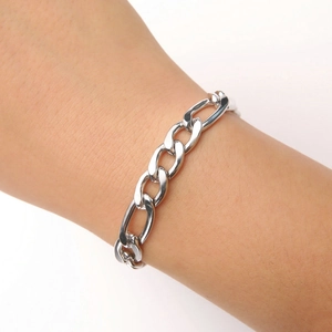Close-up of a classic silver stainless steel Cuban link chain bracelet on a wrist