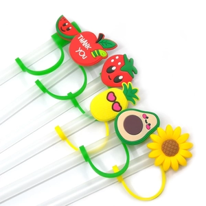 Close-up of cute silicone fruit straw toppers including strawberry and pineapple designs