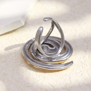 Detailed macro view of silver spiral streamline ring crafted in polished stainless steel