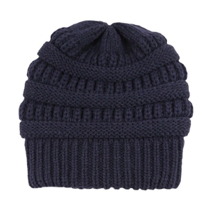 Close-up of navy blue winter beanie showing detailed knit texture and thick fabric