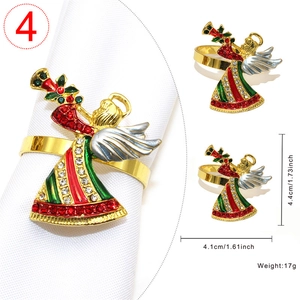 Detail of Christmas angel napkin ring featuring gold plating and enamel details
