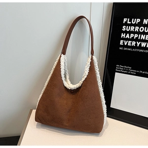 Close-up of brown suede and white fleece textures on a minimalist commuter tote bag
