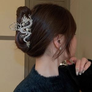 Silver dragon hair claw clip with rhinestones and pearl on elegant updo hairstyle