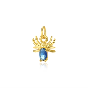 Macro shot of gold spider pendant with blue oval gemstone for jewelry making