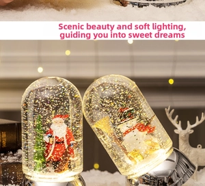 Detail of light-up Christmas crystal balls with Santa and snowman on mirrored bases
