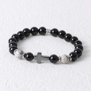Detail of 8mm tiger eye beads and black hematite bracelet with a cross charm