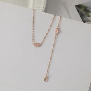 Gold chain necklace with two pink enamel heart pendants on a clean white background