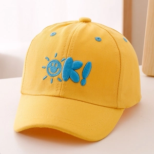 Detailed close-up of yellow cotton baseball cap with blue OK sun embroidery for kids