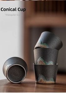 Detailed view of four conical Zen ceramic tea cups with hand-painted mountain patterns