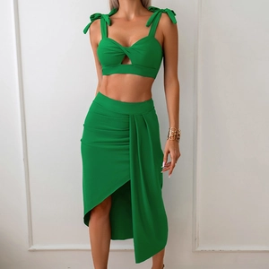 Detail of green two-piece set featuring tie-straps, front knot cutout and draped skirt