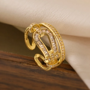 Macro detail of 18K gold plated twisted ring with sparkling trapezoid and round zircons
