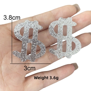 Detail shot showing 3.8cm silver glitter dollar sign earring with size dimensions