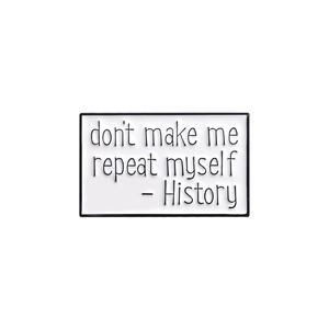 Close-up of rectangular enamel pin with History - don't make me repeat myself text