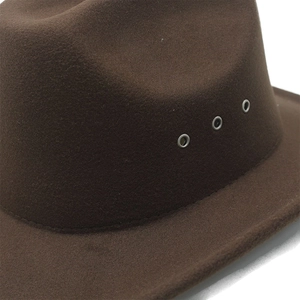Detail view of dark brown felt fedora featuring three silver metal ventilation eyelets