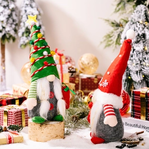 Festive Christmas gnomes in red and green with snowflake details on a snowy base