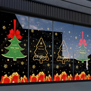 Christmas window decals set with green trees and red gift boxes on shop glass display