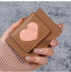 Detail of brown PU leather mini card holder featuring a pink heart-shaped cutout window